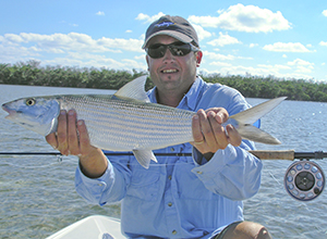 Fly fishing for bonefish this angler shows off a nice sized bonefish caught fly fishing
